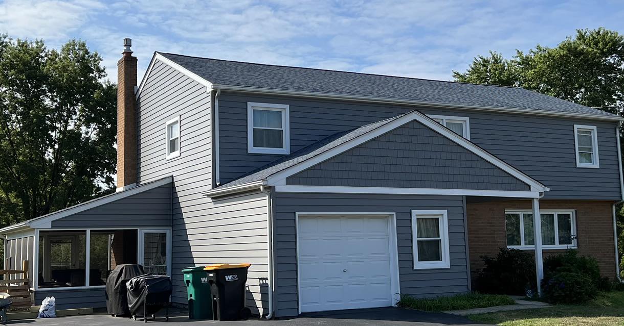 Left side view of blue-gray home after siding remodel